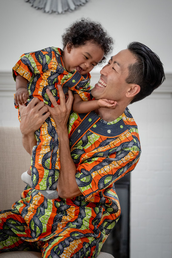 Father and son in traditional attire sharing a moment