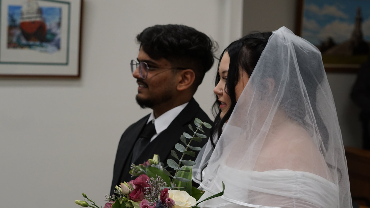 Bride and groom standing together during the ceremony