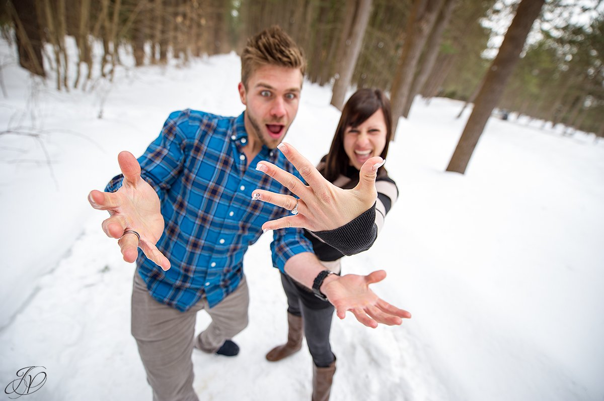 photo of engaged couple showing off the bling